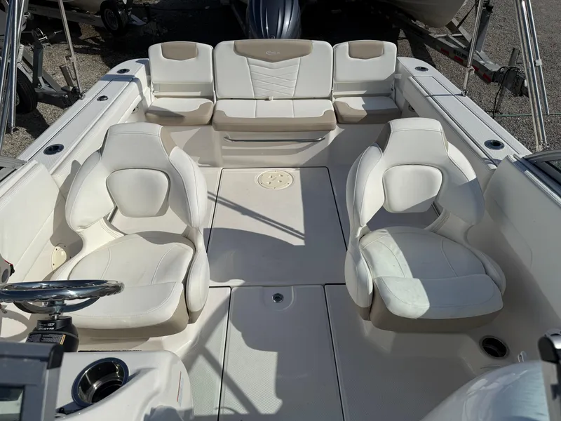 Slide: The Image of 2024 Robalo R207 Dual Console boat interior with white seating and steering wheel. - 17