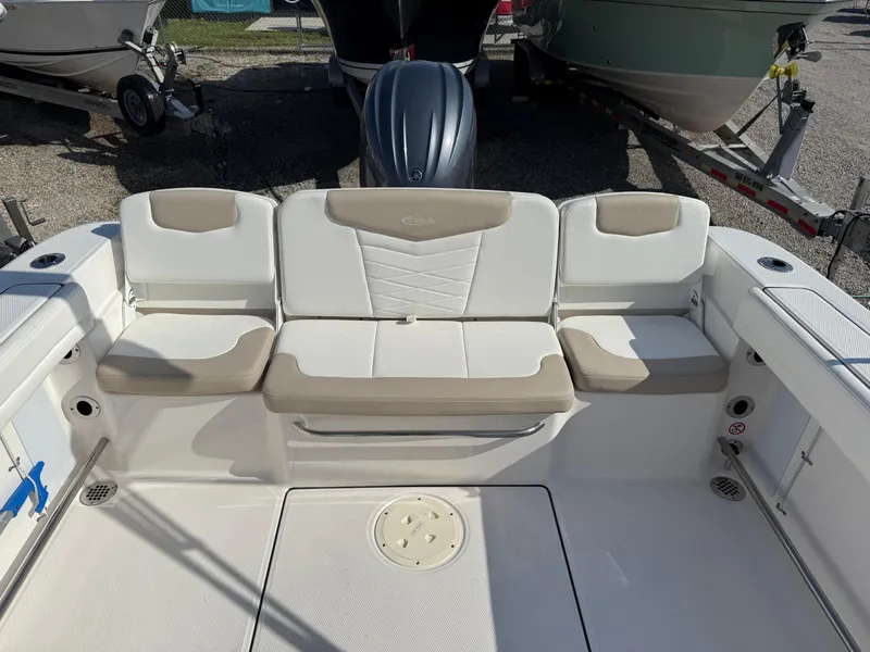 Slide: The Image of 2024 Robalo R207 Dual Console boat interior with beige and white seating. - 18