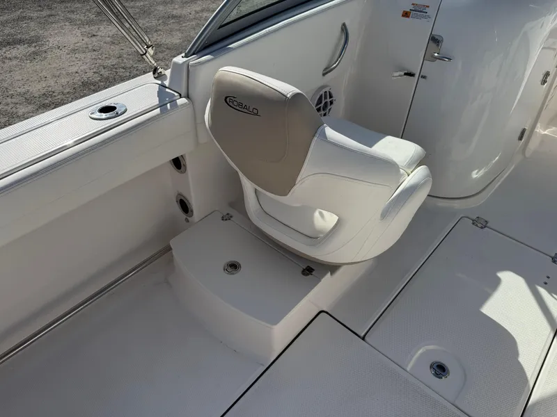 Slide: The Image of 2024 Robalo R207 Dual Console boat interior with white seating and console details. - 21