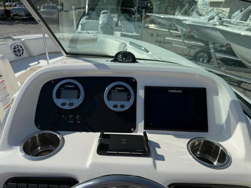 Slide: The Image of 2024 Robalo R207 Dual Console dashboard with Simrad display and gauges. - 26
