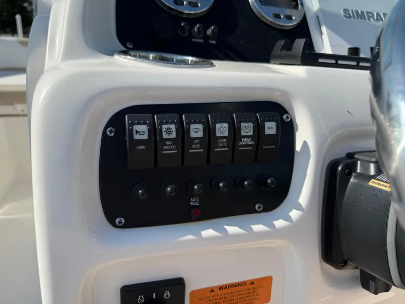 Slide: The Image of 2024 Robalo R207 Dual Console dashboard with control switches and gauges. - 27