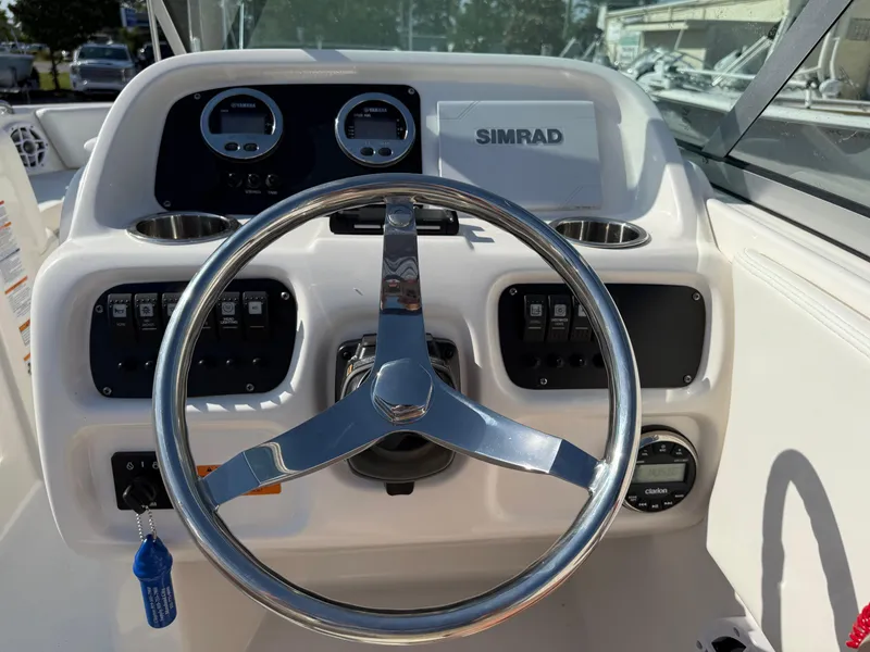 Slide: The Image of 2024 Robalo R207 Dual Console boat dashboard with steering wheel and Simrad display. - 29