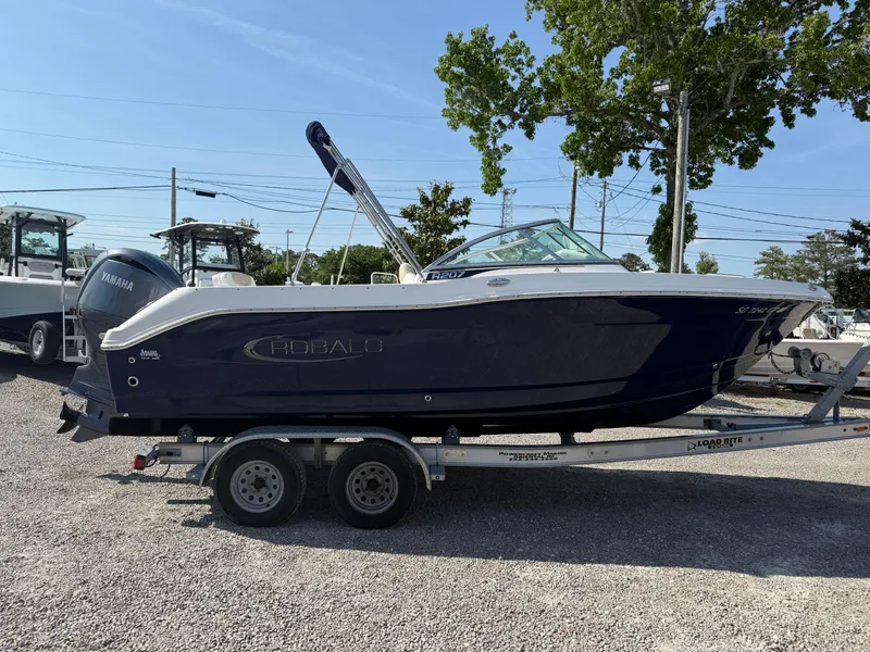 Slide: The Image of 2024 Robalo R207 Dual Console boat on trailer, parked outdoors. - 3