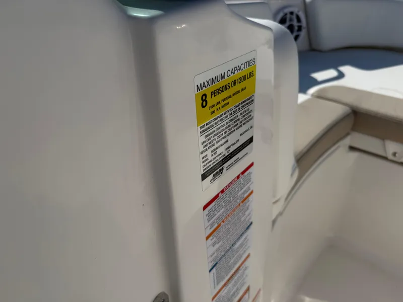 Slide: The Image of 2024 Robalo R207 Dual Console boat capacity label, seating for 8 people, 1200 lbs limit. - 30