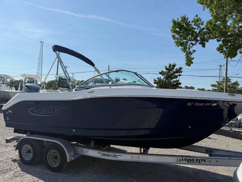 Slide: The Image of 2024 Robalo R207 Dual Console boat on trailer, parked outdoors. - 4