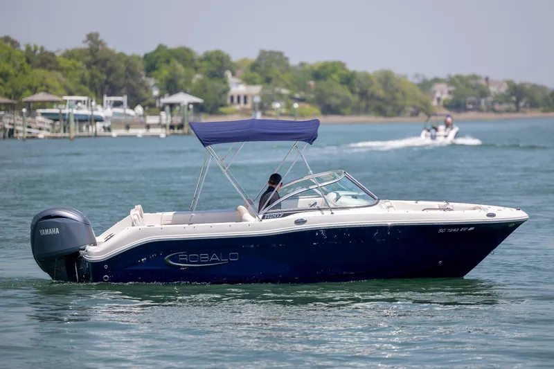 Slide: The Image of 2024 Robalo R207 Dual Console boat cruising on a sunny day with Yamaha engine. - 49