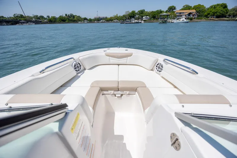 Slide: The Image of 2024 Robalo R207 Dual Console boat interior with spacious seating on calm water. - 52