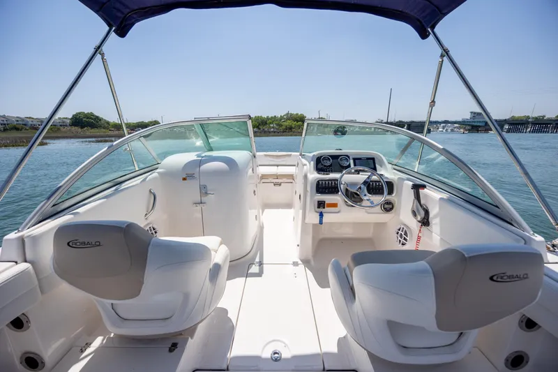 Slide: The Image of 2024 Robalo R207 Dual Console boat interior with steering wheel and seating. - 59