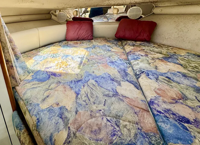 Slide: The Image of 1999 Chaparral 290 Signature Cruiser interior with colorful bedding and red pillows. - 11