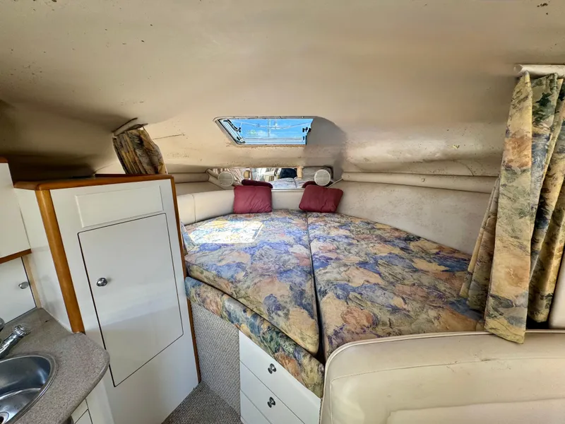 Slide: The Image of 1999 Chaparral 290 Signature Cruiser cabin with cozy bed and skylight. - 12