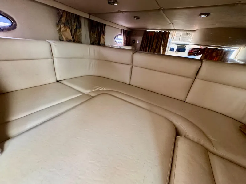 Slide: The Image of 1999 Chaparral 290 Signature Cruiser interior with beige seating and windows. - 14