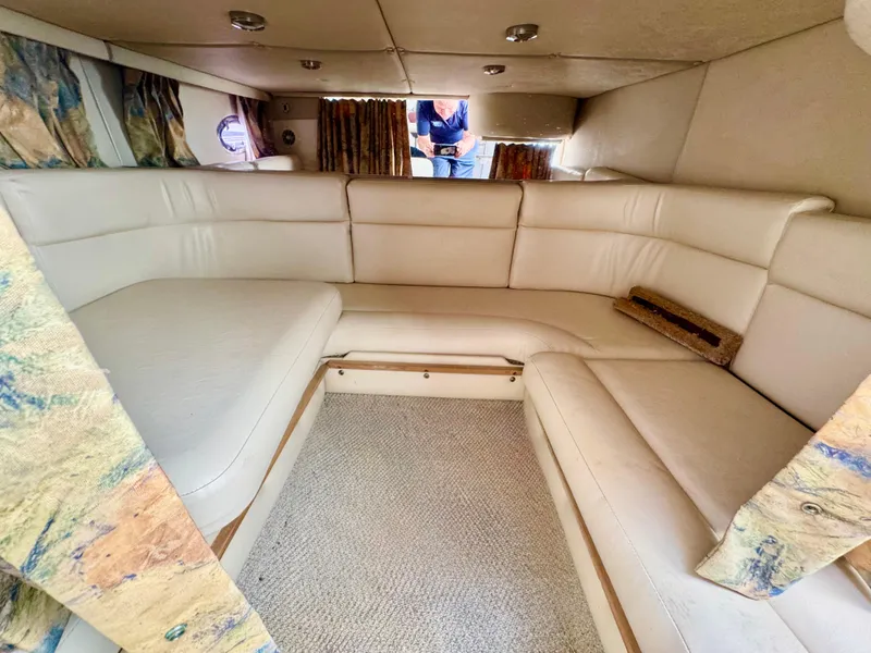 Slide: The Image of 1999 Chaparral 290 Signature Cruiser interior with beige seating and carpet. - 16