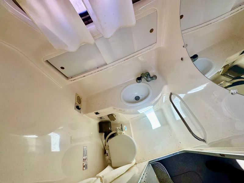 Slide: The Image of 1999 Chaparral 290 Signature Cruiser bathroom with sink, toilet, and mirror. - 17