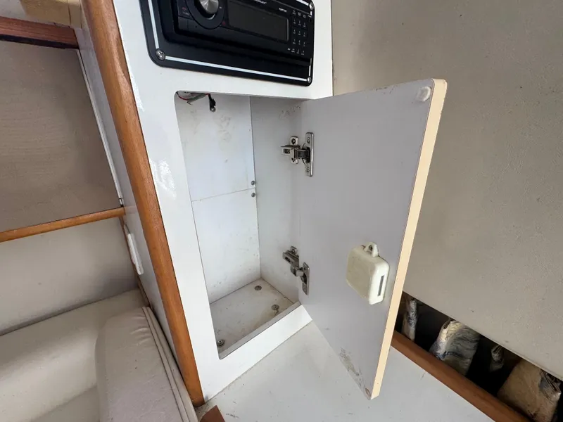 Slide: The Image of 1999 Chaparral 290 Signature Cruiser interior with open cabinet and stereo system. - 22