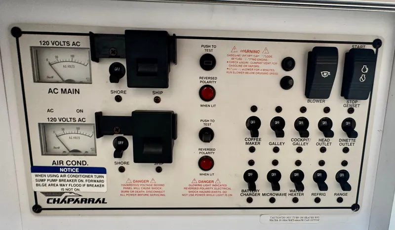 Slide: The Image of Control panel of a 1999 Chaparral 290 Signature Cruiser with various switches and indicators. - 24