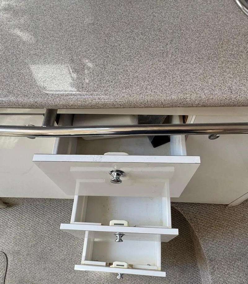 Slide: The Image of Open drawers in a Chaparral 290 Signature Cruiser, 1999 model, with a granite-like countertop. - 27