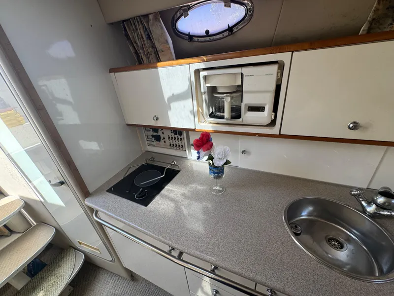 Slide: The Image of Interior of 1999 Chaparral 290 Signature Cruiser with kitchenette, sink, and coffee maker. - 35