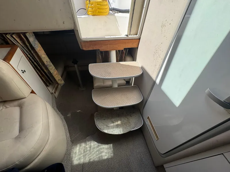 Slide: The Image of Interior of 1999 Chaparral 290 Signature Cruiser with compact stairs and seating area. - 37
