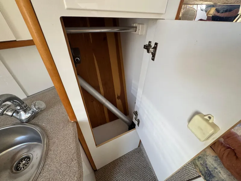 Slide: The Image of Open cabinet in 1999 Chaparral 290 Signature Cruiser, showing interior storage space. - 39