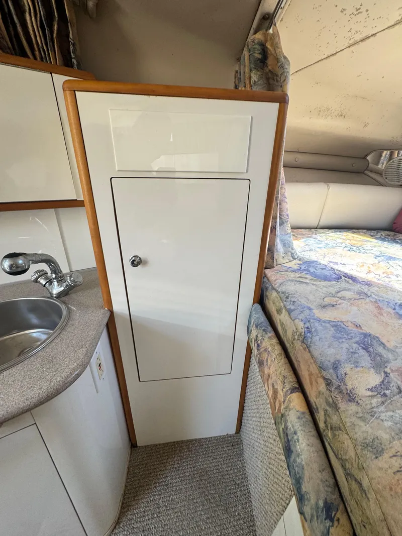 Slide: The Image of Interior of 1999 Chaparral 290 Signature Cruiser with sink, cabinet, and bed. - 40