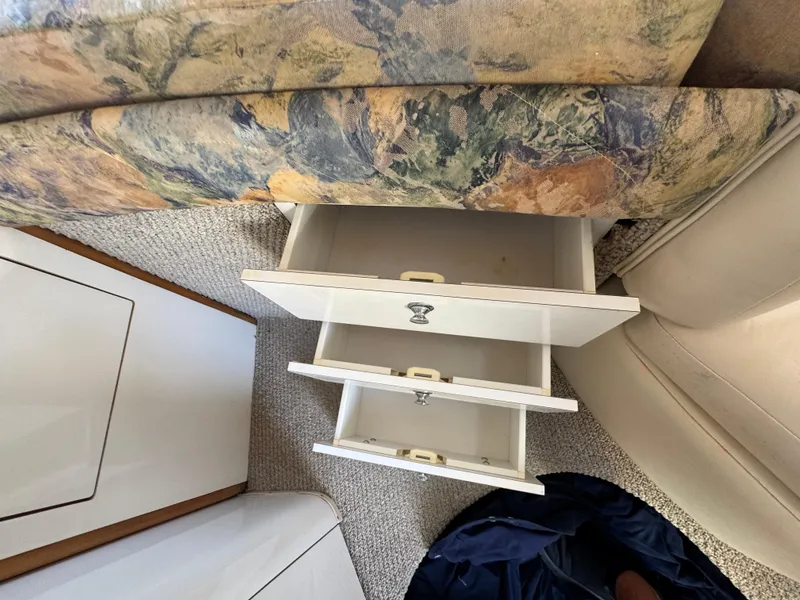 Slide: The Image of Interior of 1999 Chaparral 290 Signature Cruiser with open white drawers and patterned upholstery. - 41