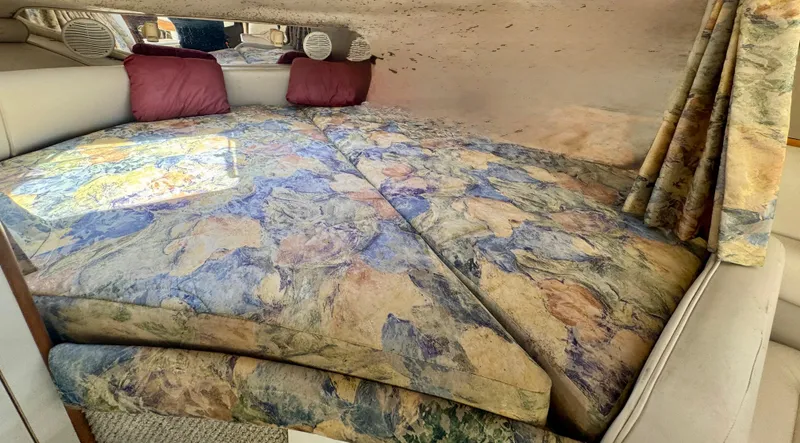 Slide: The Image of 1999 Chaparral 290 Signature Cruiser interior with patterned bedding and pillows. - 42