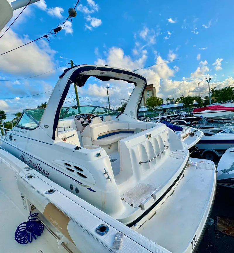 Slide: The Image of 1999 Chaparral 290 Signature Cruiser docked under a vibrant blue sky. - 47