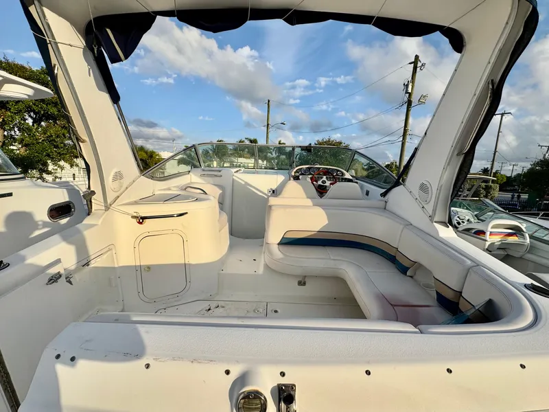 Slide: The Image of 1999 Chaparral 290 Signature Cruiser interior with seating and steering wheel under blue sky. - 49