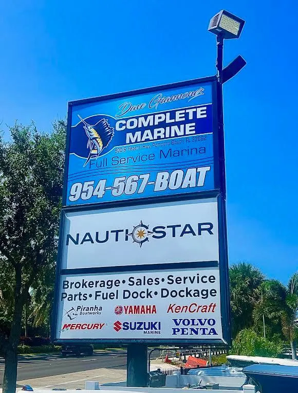 Slide: The Image of Complete Marine service sign with contact details and marine brands under clear blue sky. - 58