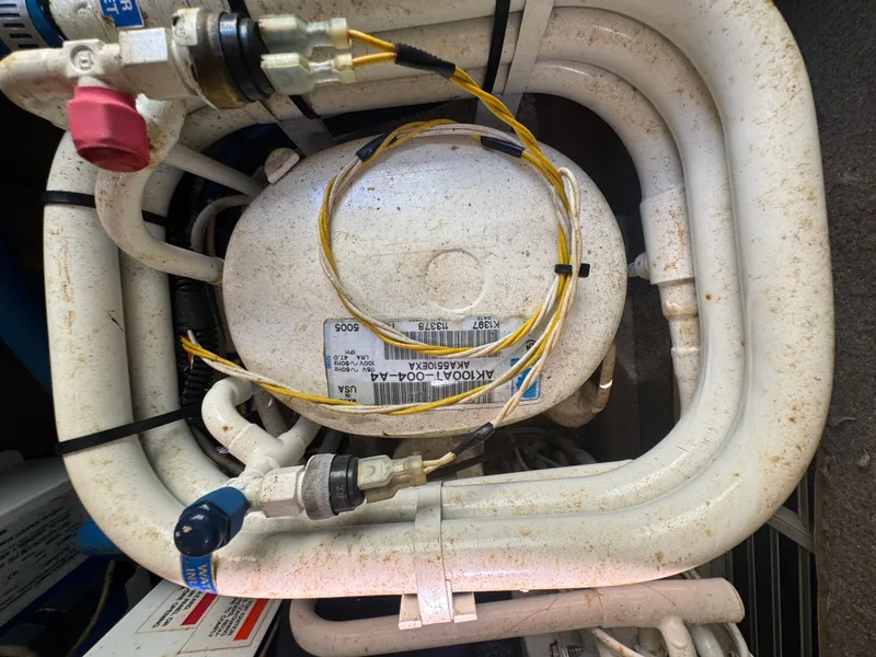 Slide: The Image of Engine component of a 1999 Chaparral 290 Signature Cruiser with visible wiring and labels. - 67