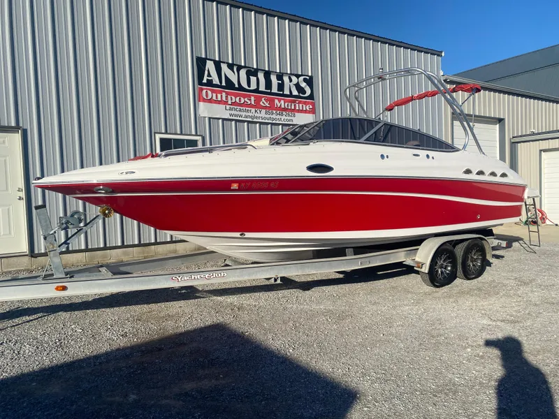 Slide: The Image of 2011 Ebbtide 2700 Cuddy Bow Rider boat on trailer, parked outside Angler's Outpost & Marine. - 1