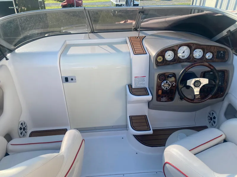 Slide: The Image of 2011 Ebbtide 2700 Cuddy Bow Rider cockpit with steering wheel and dashboard controls. - 13