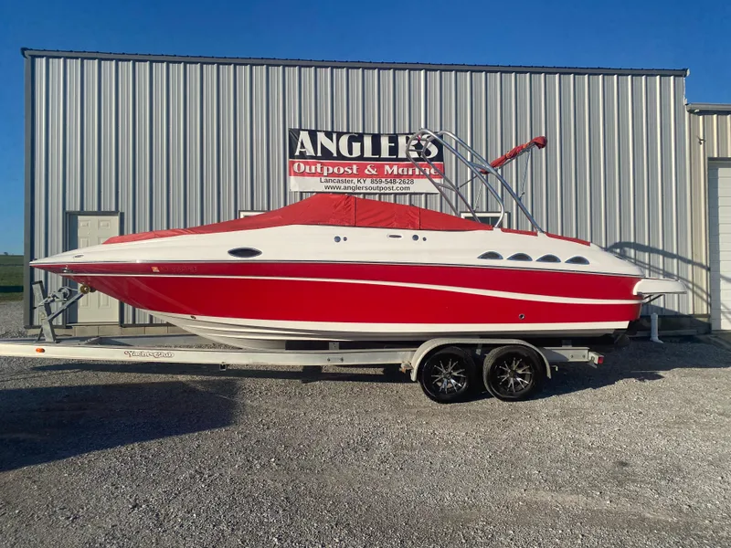 Slide: The Image of 2011 Ebbtide 2700 Cuddy Bow Rider boat in red and white on trailer. - 20