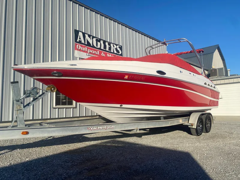 Slide: The Image of Red 2011 Ebbtide 2700 Cuddy Bow Rider boat on trailer, parked outside Anglers Outpost. - 21