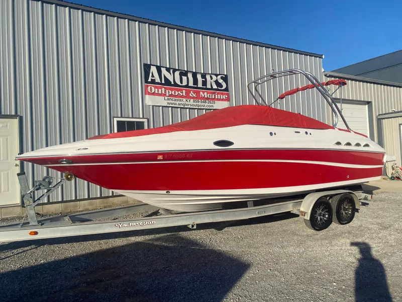 Slide: The Image of 2011 Ebbtide 2700 Cuddy Bow Rider boat in red and white on trailer. - 22