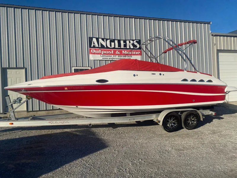 Slide: The Image of 2011 Ebbtide 2700 Cuddy Bow Rider boat in red on trailer outside Angler's Outpost & Marine. - 23