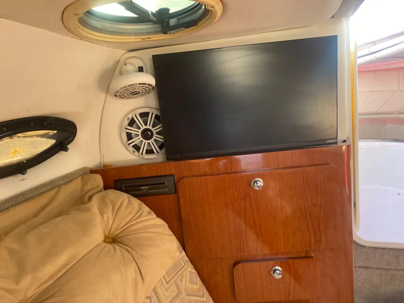 Slide: The Image of Interior of 2011 Ebbtide 2700 Cuddy Bow Rider with TV, speaker, and wood cabinetry. - 7