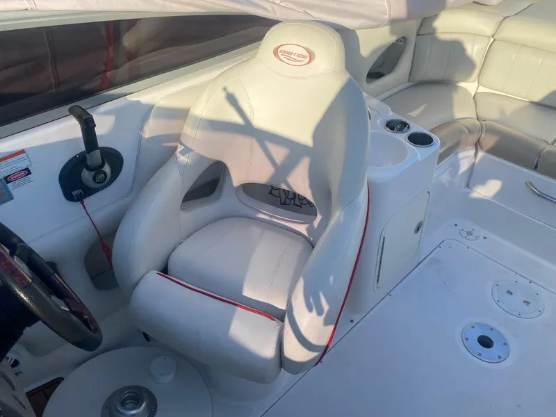 Slide: The Image of 2011 Ebbtide 2700 Cuddy Bow Rider interior with white seating and control panel. - 8