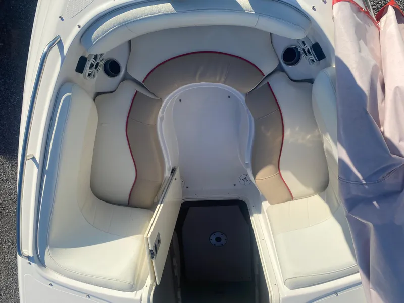 Slide: The Image of 2011 Ebbtide 2700 Cuddy Bow Rider interior with white seating and red accents. - 9