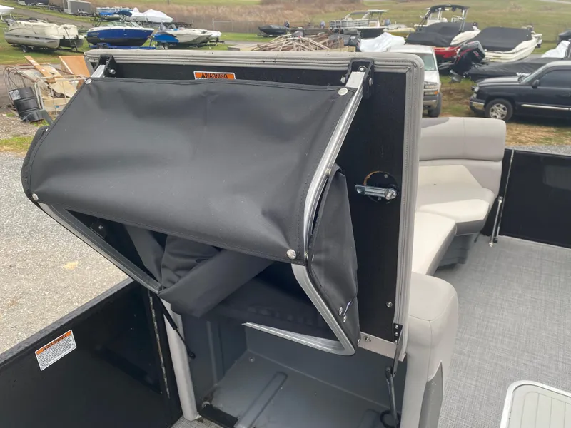 Slide: The Image of 2023 SunChaser Eclipse 8523 SBX boat interior with storage compartment and seating. - 12