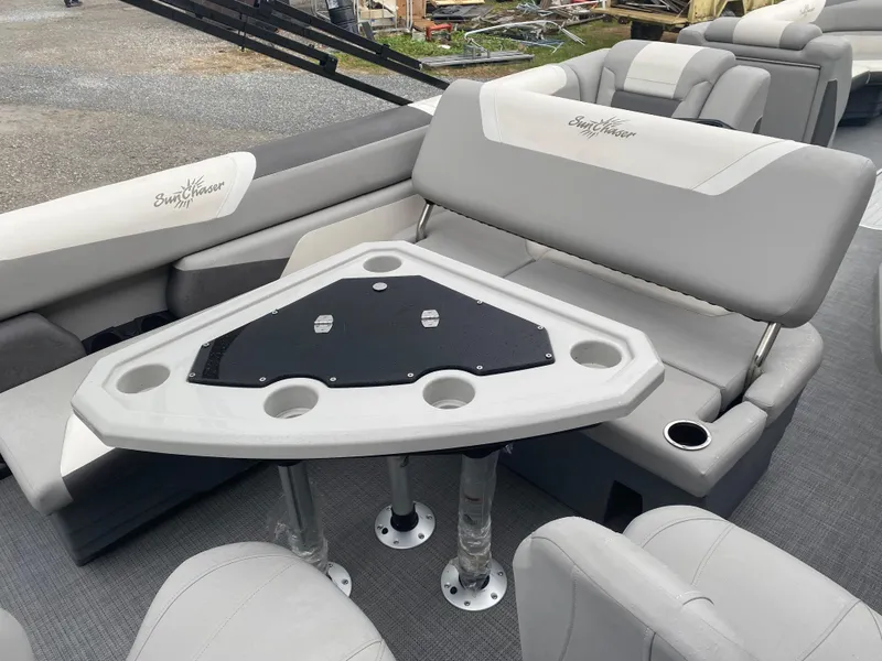 Slide: The Image of 2023 SunChaser Eclipse 8523 SBX boat interior with gray seating and a triangular table. - 13