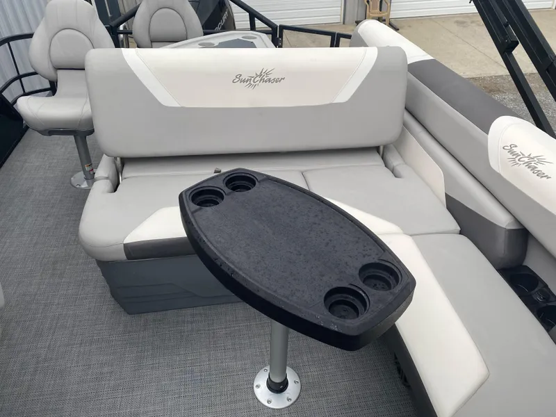 Slide: The Image of 2023 SunChaser Eclipse 8523 SBX boat interior with seating and cupholder table. - 17