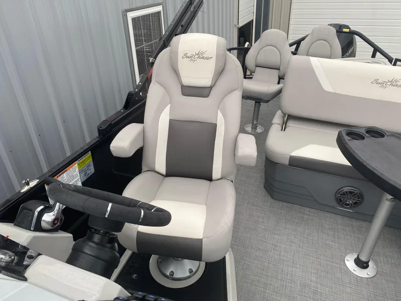 Slide: The Image of 2023 SunChaser Eclipse 8523 SBX boat interior with captain's chair and seating area. - 19