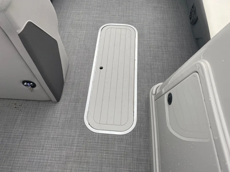 Slide: The Image of 2023 SunChaser Eclipse 8523 SBX boat interior with gray flooring and storage compartment. - 20