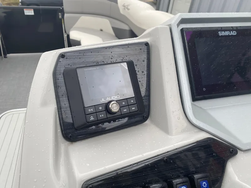 Slide: The Image of Control panel of 2023 SunChaser Eclipse 8523 SBX boat with JL Audio and Simrad displays. - 22