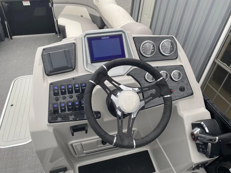 Slide: The Image of 2023 SunChaser Eclipse 8523 SBX boat dashboard with steering wheel and control panel. - 23