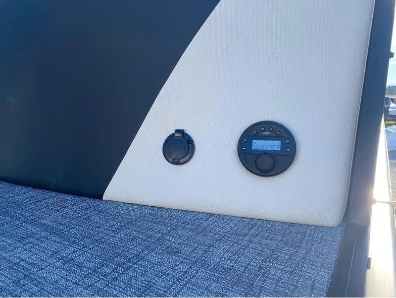 Slide: The Image of 2024 Trifecta 23 RFS 3.0 boat interior with control panel and textured upholstery. - 10