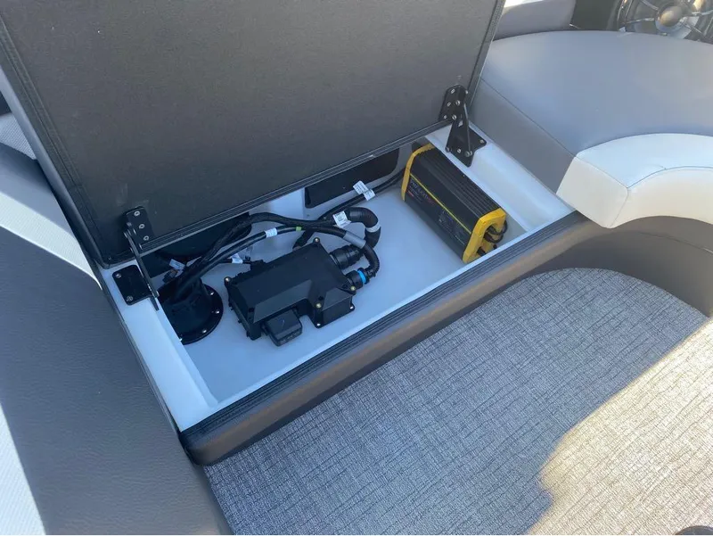 Slide: The Image of 2024 Trifecta 23 RFS 3.0 boat storage compartment with electronic components and wiring. - 13