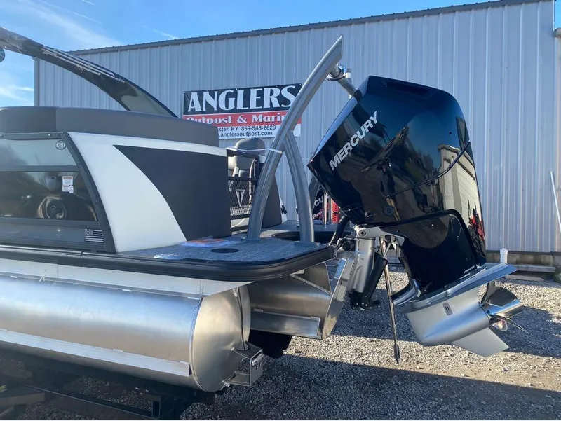 Slide: The Image of 2024 Trifecta 23 RFS 3.0 pontoon boat with Mercury outboard motor at dealership. - 15