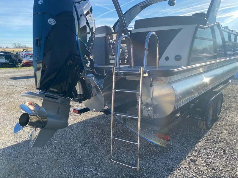 Slide: The Image of 2024 Trifecta 23 RFS 3.0 pontoon boat with powerful outboard motor and ladder. - 2